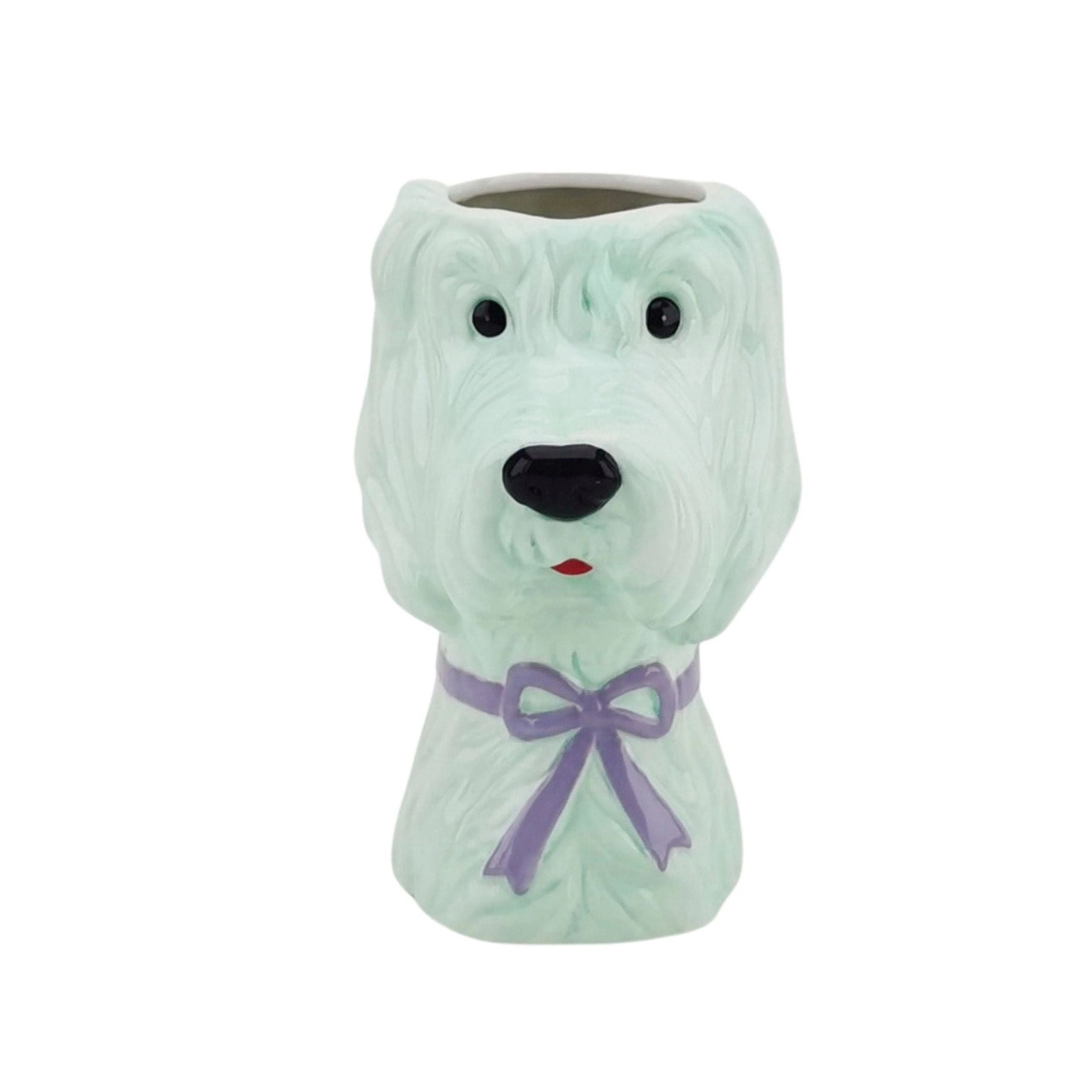 Mint green dog-shaped ceramic vase with a lilac bow, shown against a white background.
