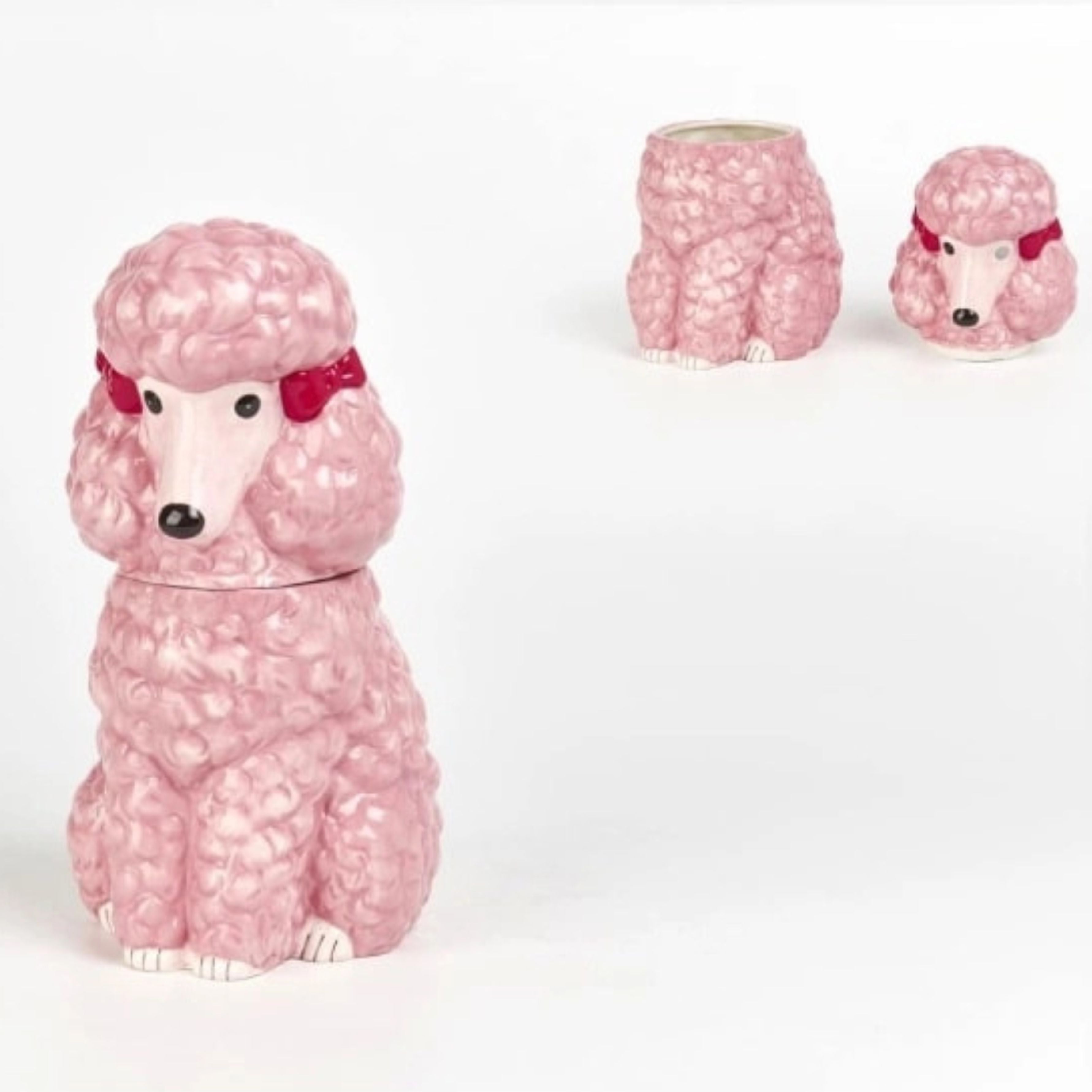 Pink ceramic poodle storage jar shown open with removable lid on white background