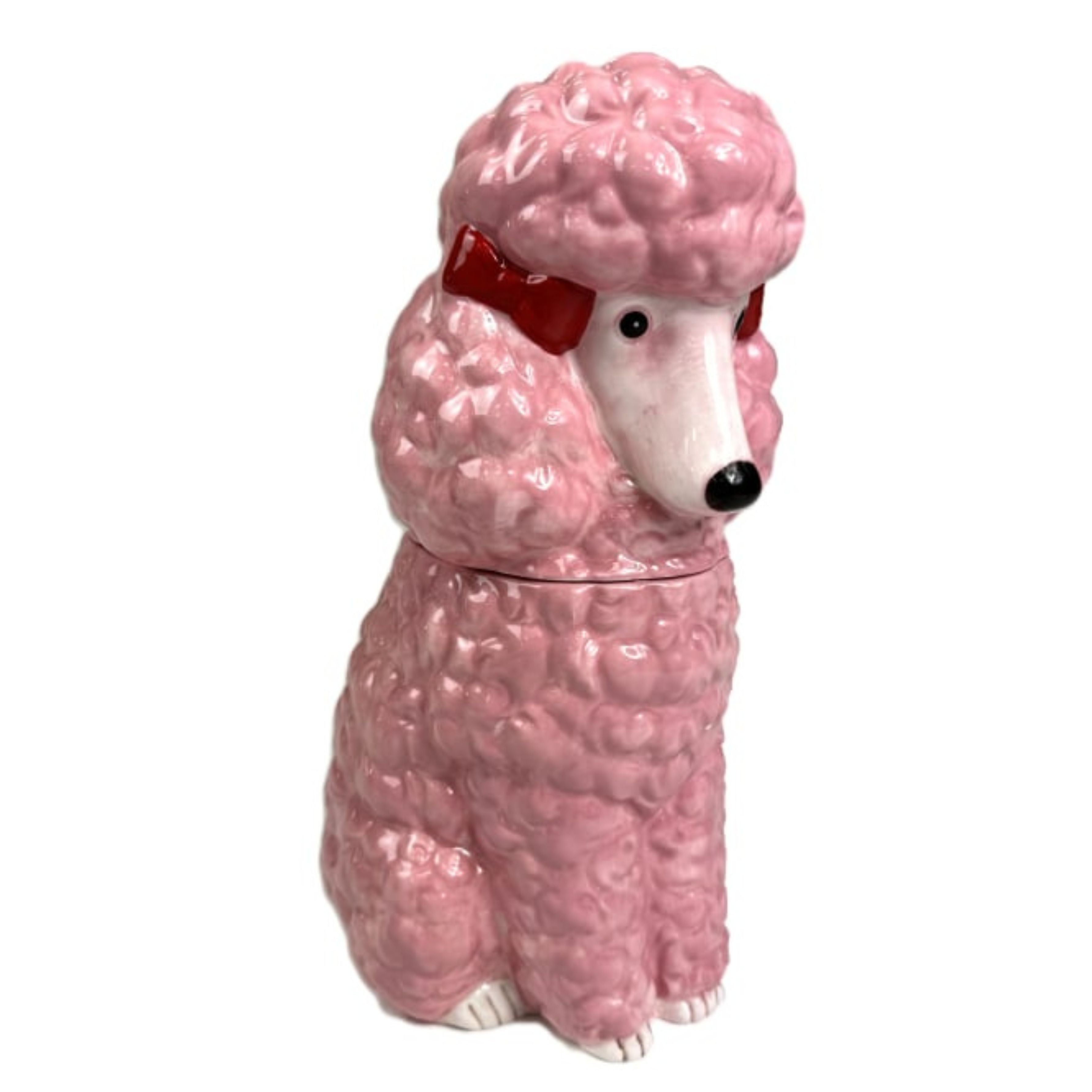 Pink ceramic poodle storage jar with red bow detail shown closed on white background