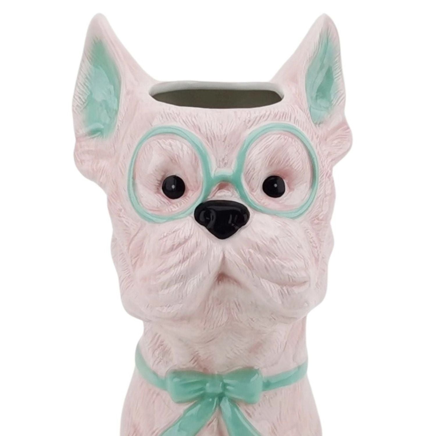 Pink dog-shaped vase with mint green glasses and matching bow tie on a white background.