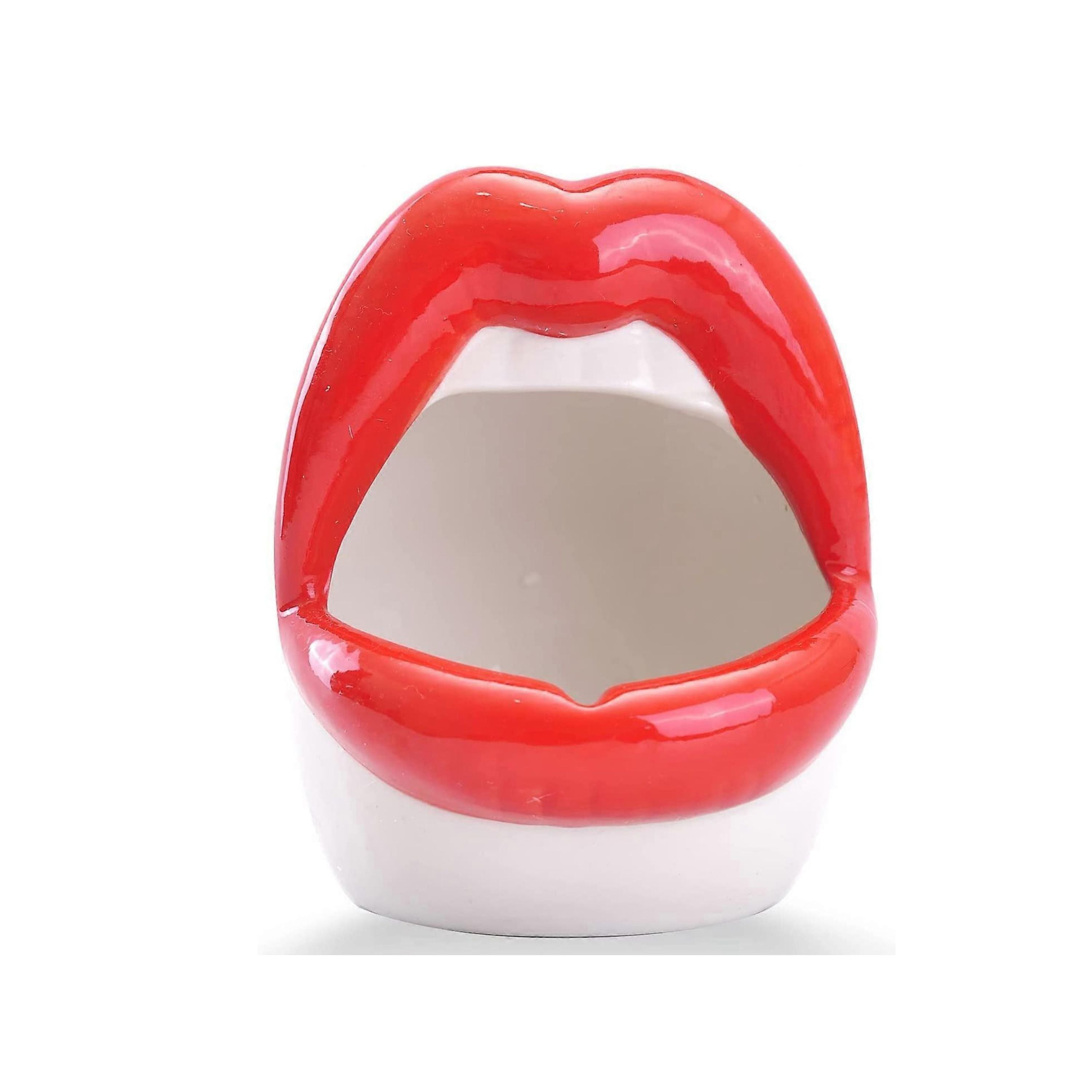 Red lip-shaped ceramic planter filled with trailing green houseplant on a clean white background