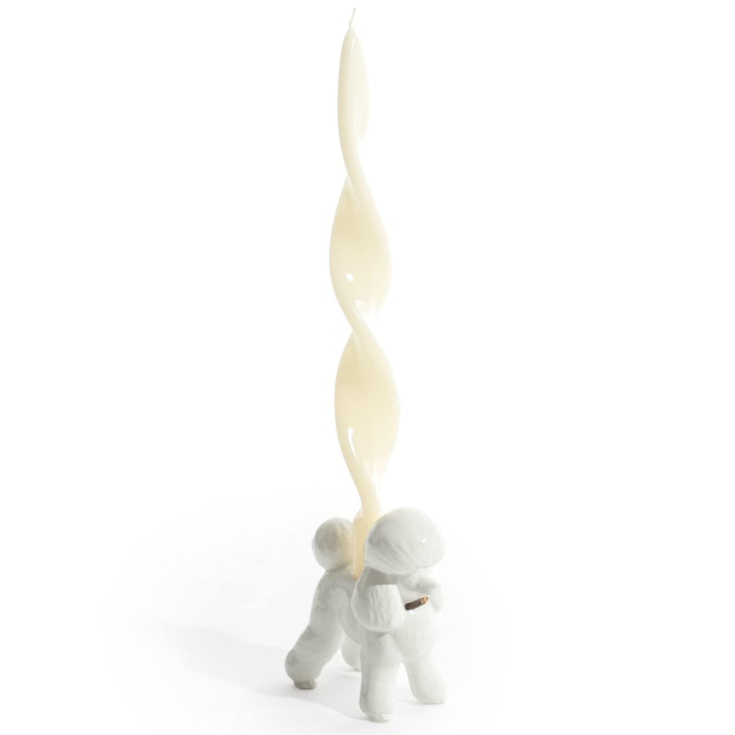 White ceramic poodle candle holder holding a twisted dinner candle on white background