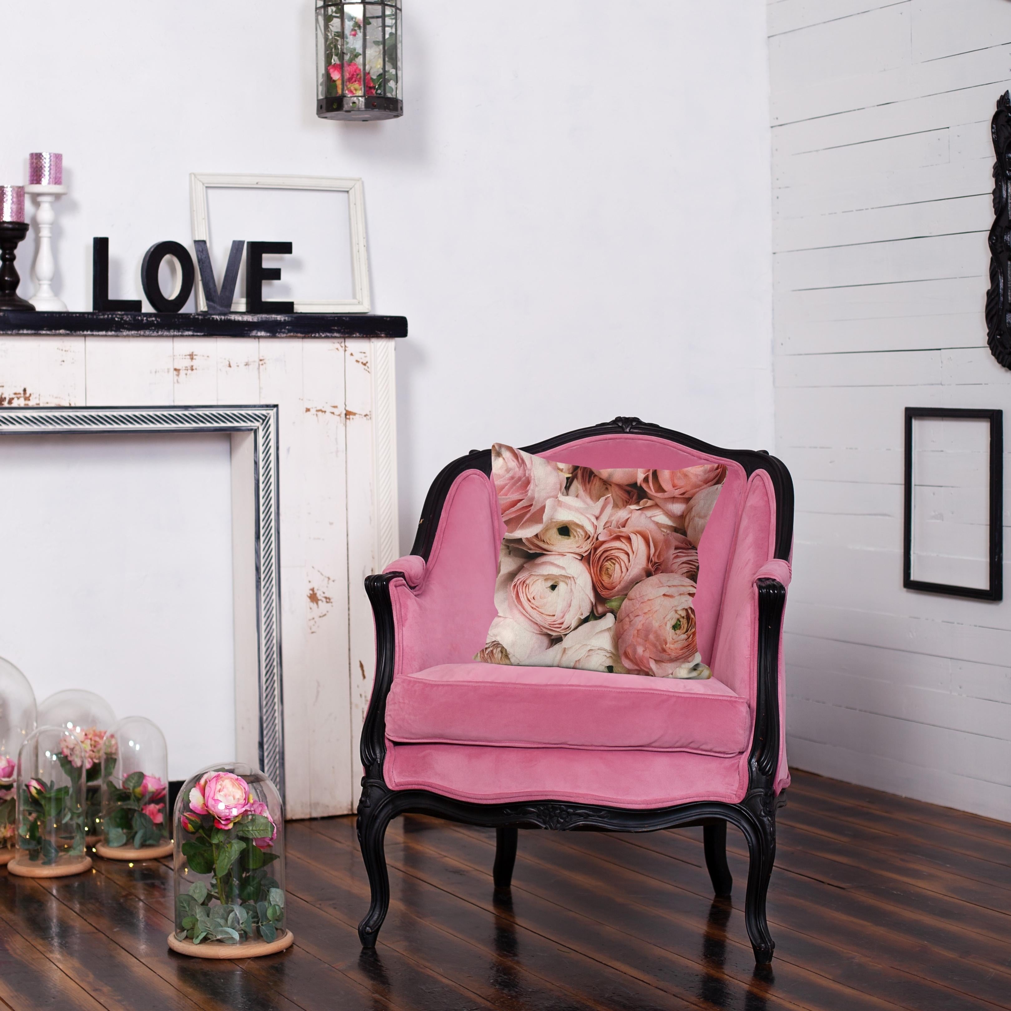 Roses in Shades of Pink cushion styled on a pink velvet chair beside a white fireplace – Lizzie Onion’s Emporium