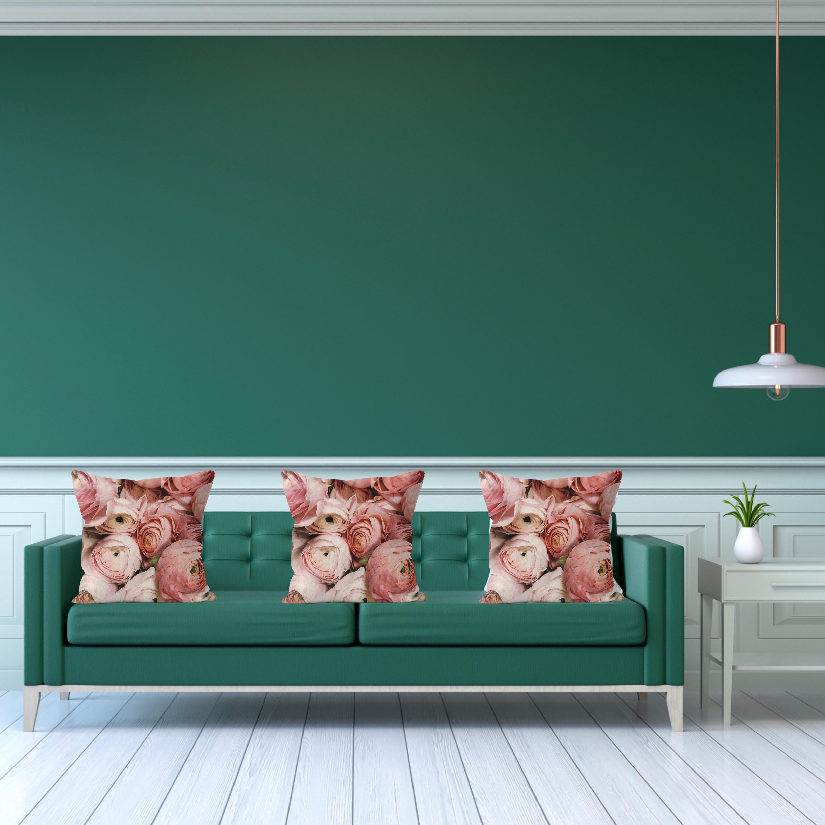 Roses in Shades of Pink cushions on a green sofa with white wall panelling – Lizzie Onion’s Emporium