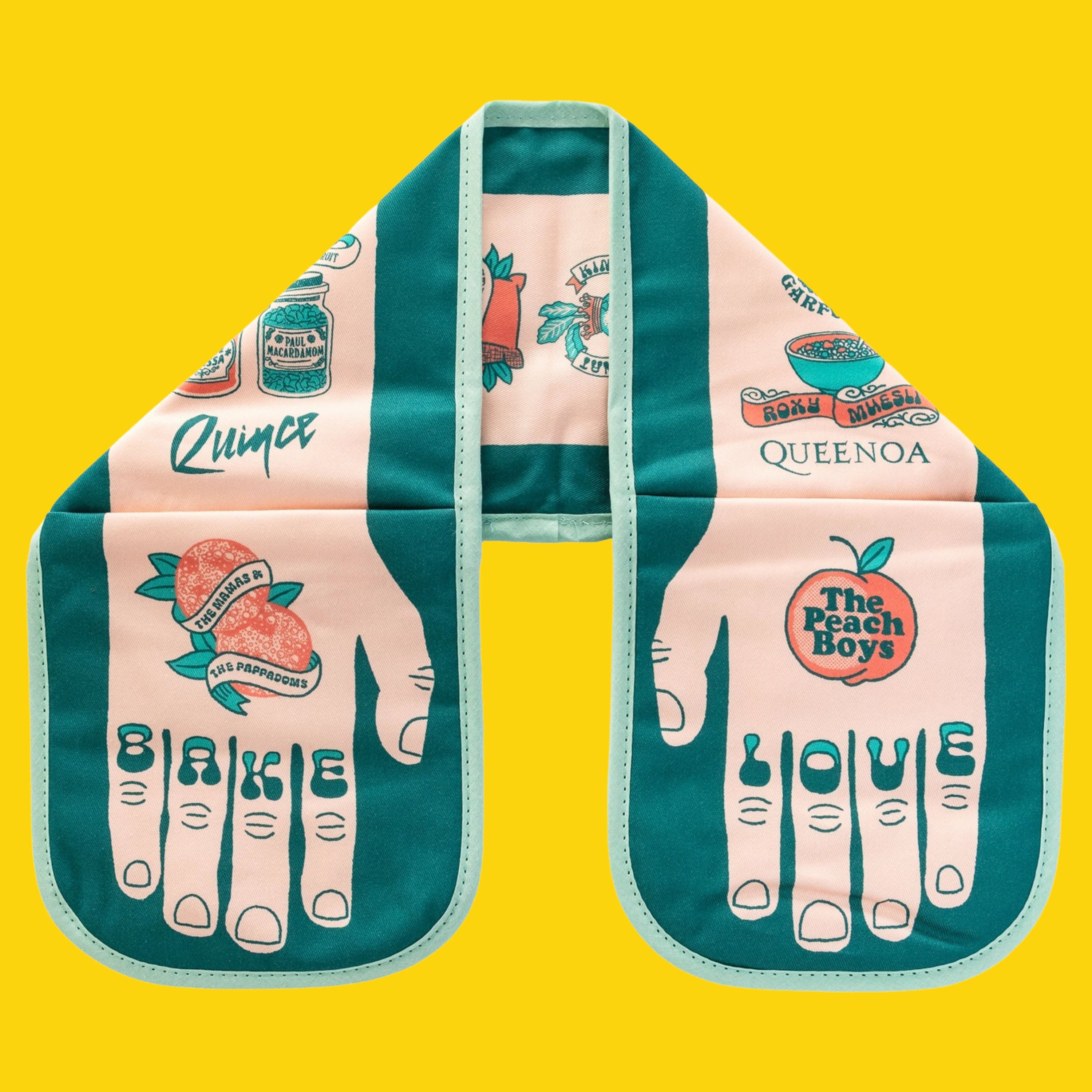 Bake Love double oven glove with teal and peach illustrated food-and-music puns and “BAKE” and “LOVE” on the fingertips, displayed flat on a bright yellow background.