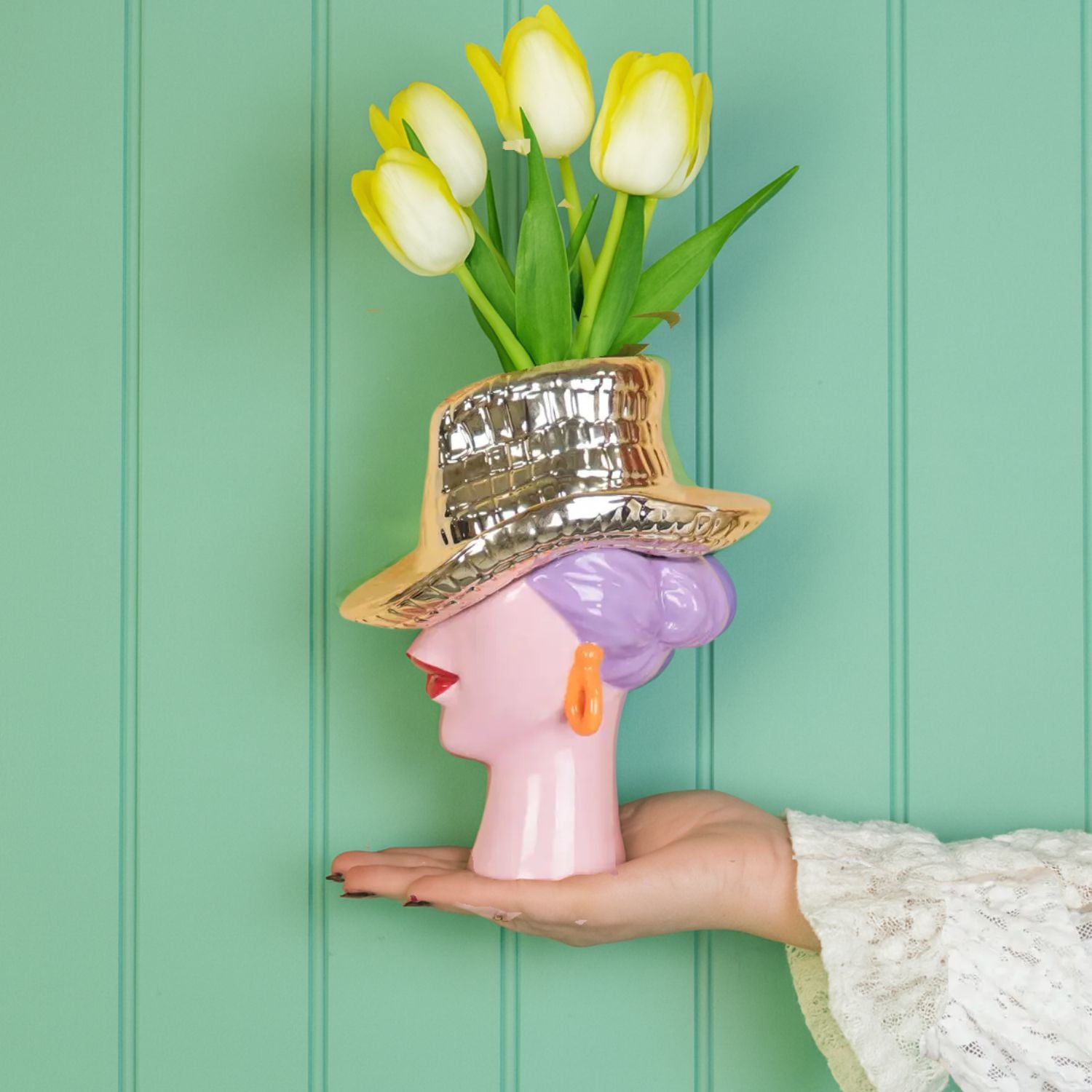 Gold cowboy hat lady vase with lilac hair and tulips against a mint green panelled wall – playful statement décor by Lizzie Onion’s Emporium