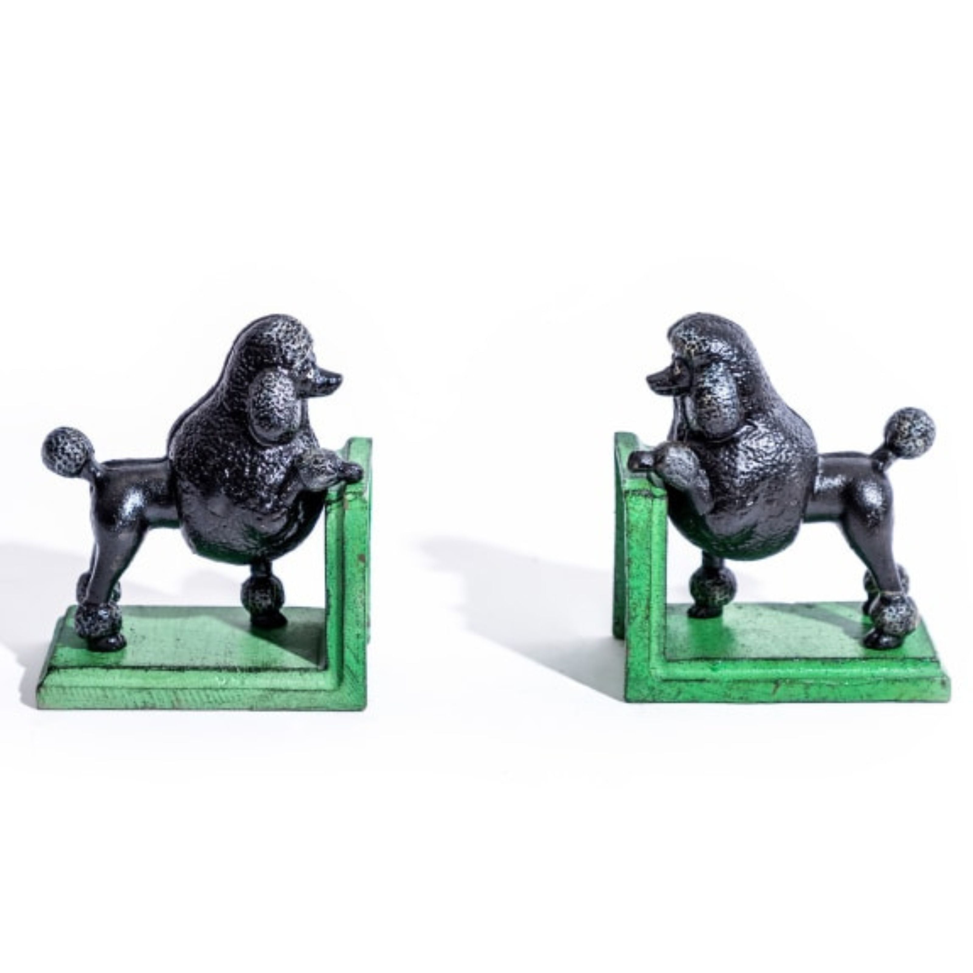 Pair of cast iron black poodle bookends with green bases, shown facing each other on a white background – vintage-style decorative home accessories.