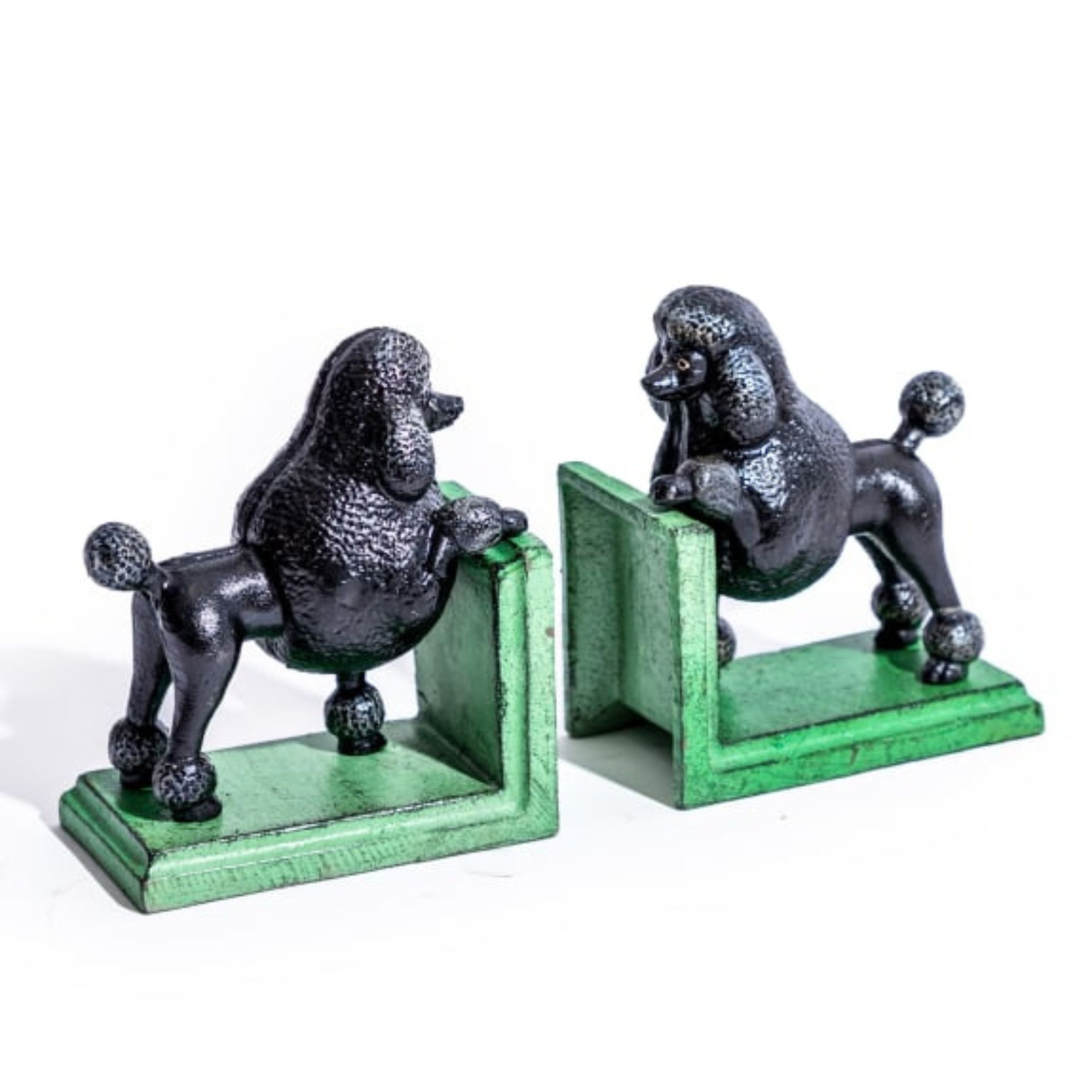 Pair of cast iron black poodle bookends with vintage green bases, positioned side by side on a clean white background, showcasing their detailed finish.