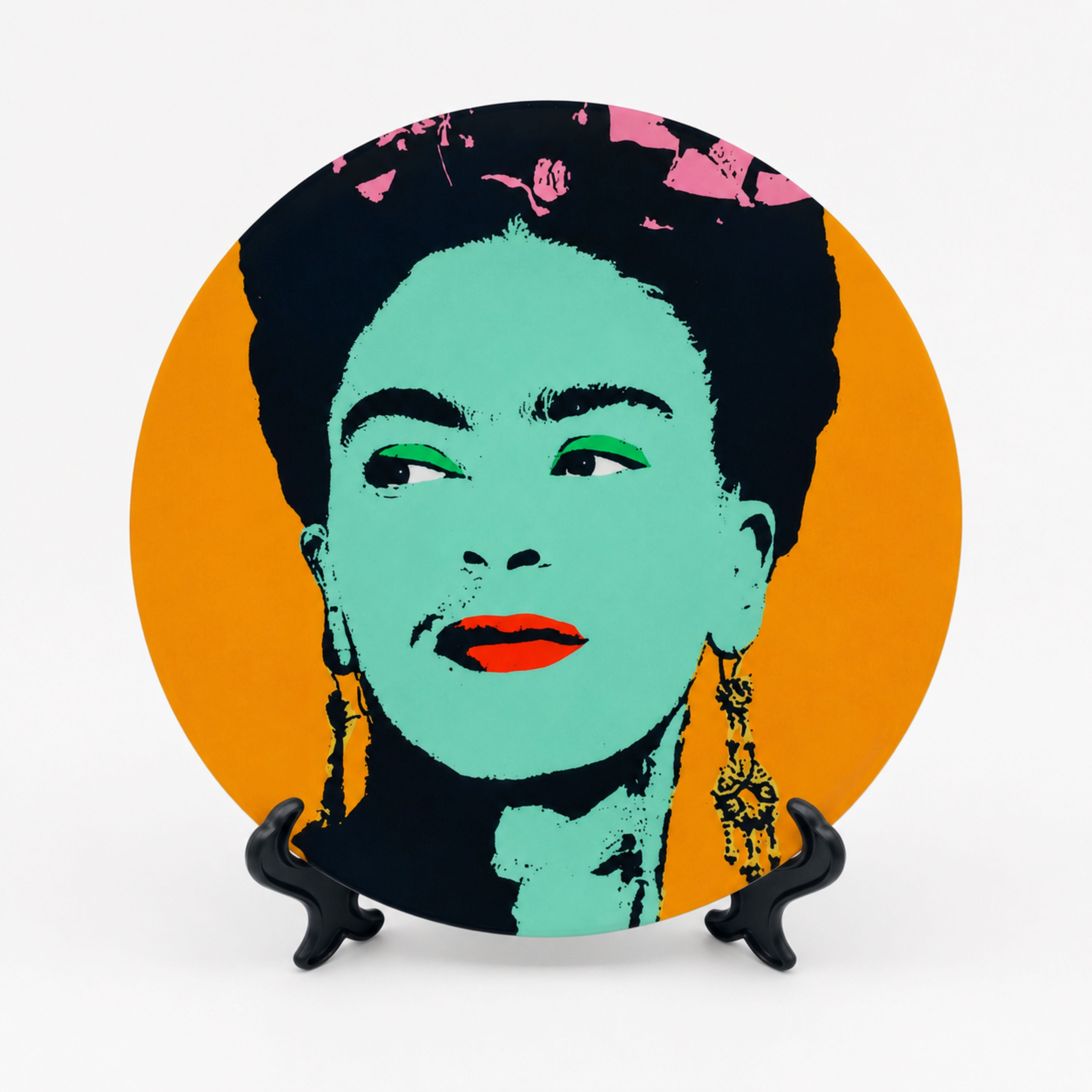Pop art inspired Frida Kahlo decorative plate in orange, mint green and black on a white background