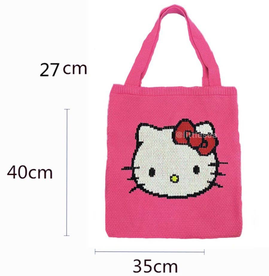 Size guide showing a pink knitted Hello Kitty tote bag with integrated handles, featuring the iconic Hello Kitty face motif and dimensions of 40 cm high, 35 cm wide and 27 cm handle height, on a white background.