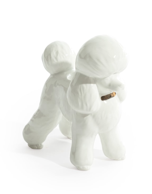 White ceramic poodle candle holder with gold collar detail on white background