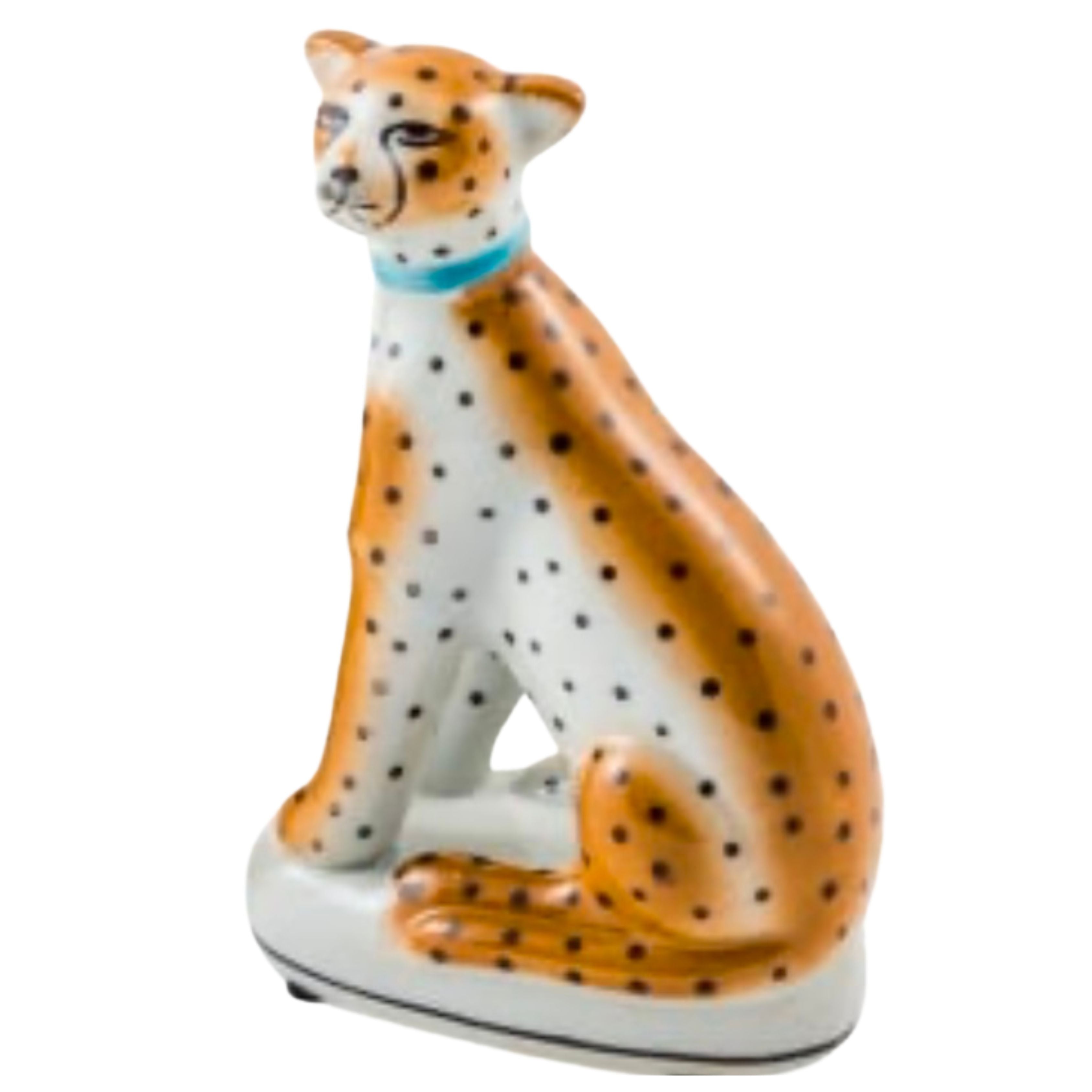 ceramic leopard ornament with orange and black spotted detail sitting decorative figure on white background