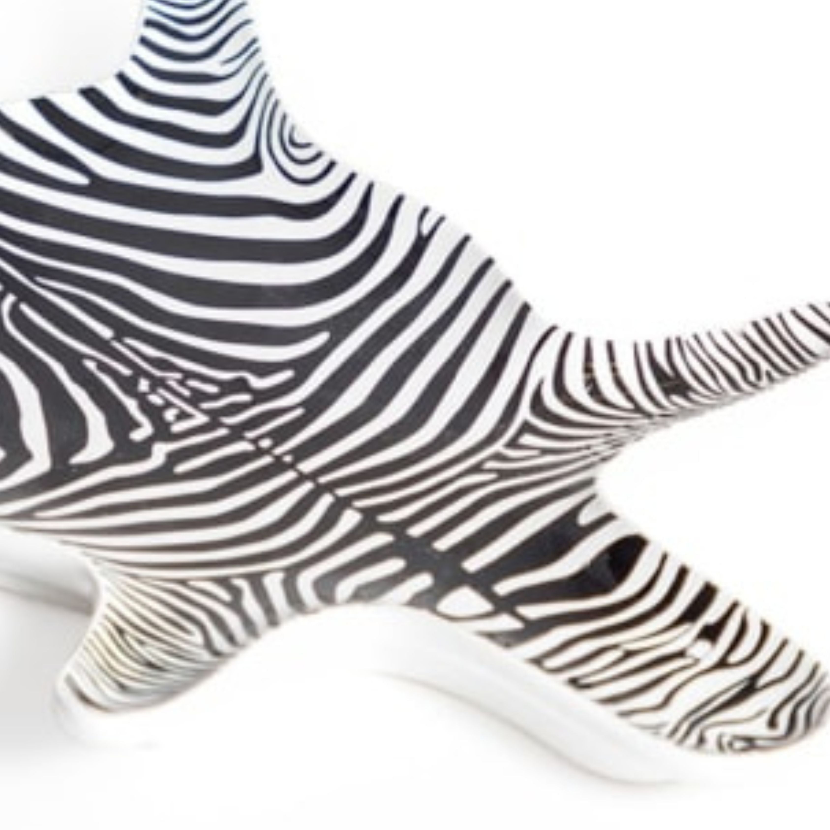 close up of black and white zebra print ceramic trinket dish showing striped pattern detail