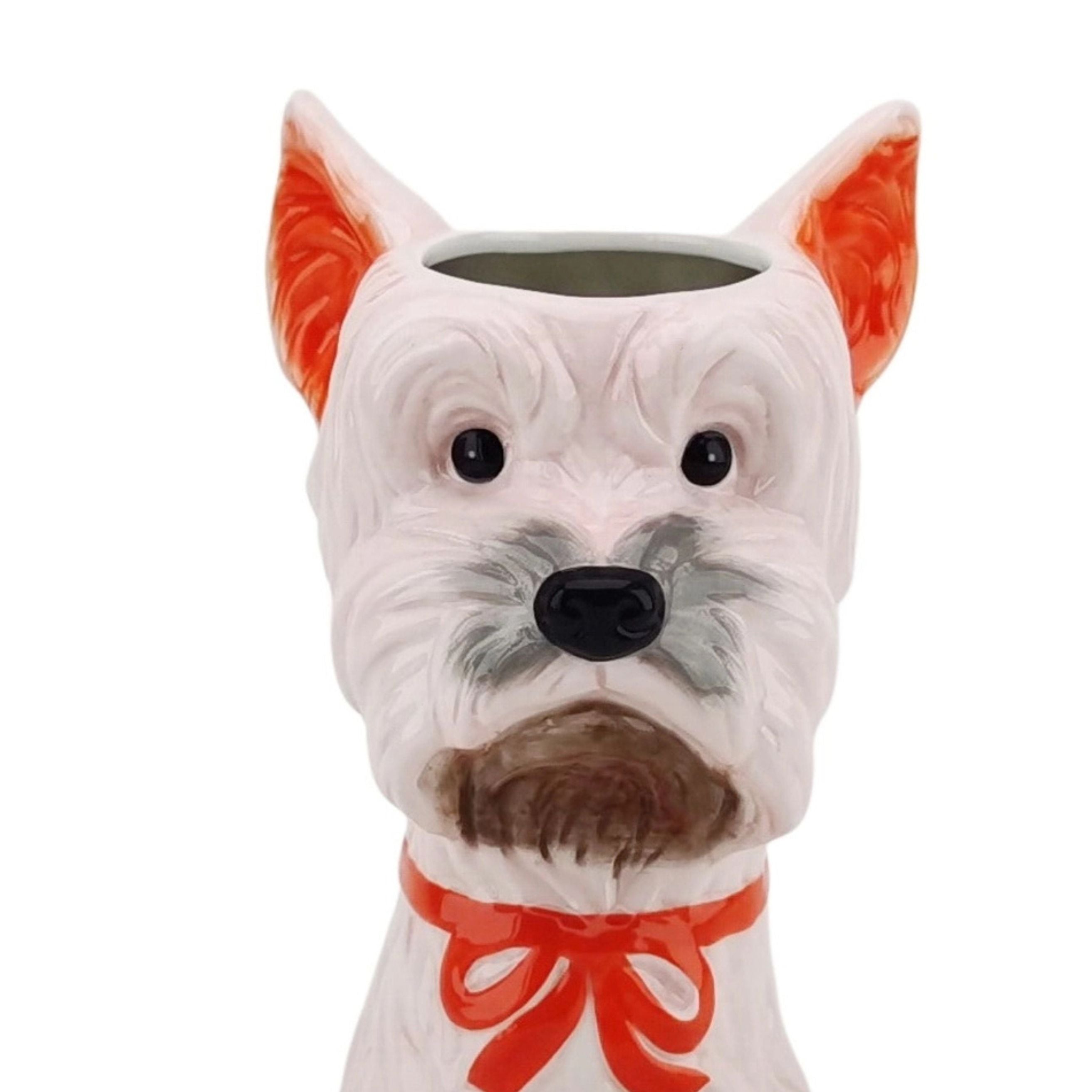 dog-shaped ceramic flower vase in pink and orange with a bow on a white background