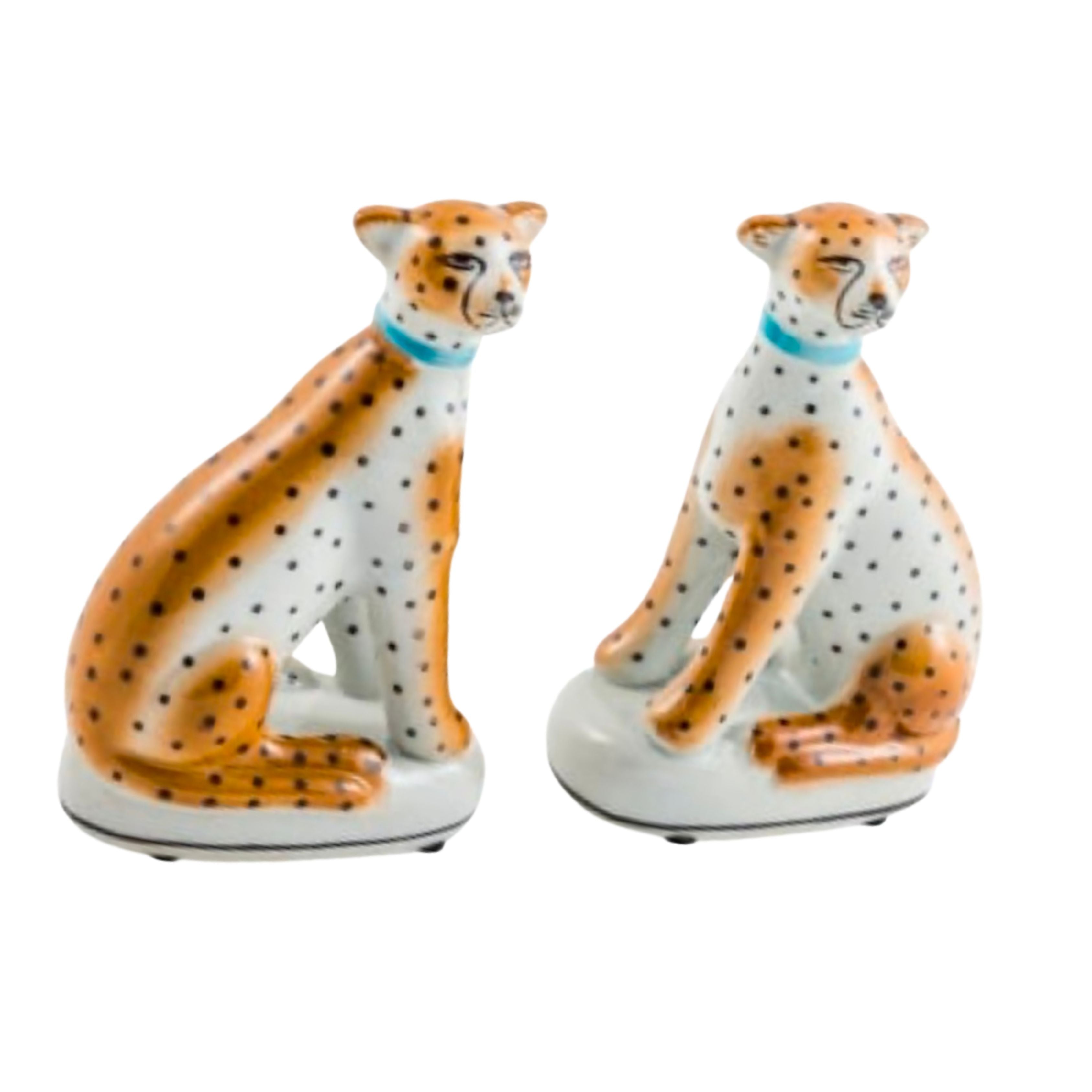 pair of ceramic sitting leopard figures with orange and black spots on white background decorative ornaments