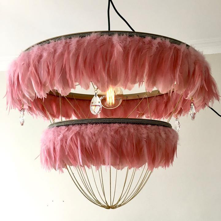 Two-tier Bertie feather light shade in vibrant flamingo pink with crystal drops, hanging against a neutral background.